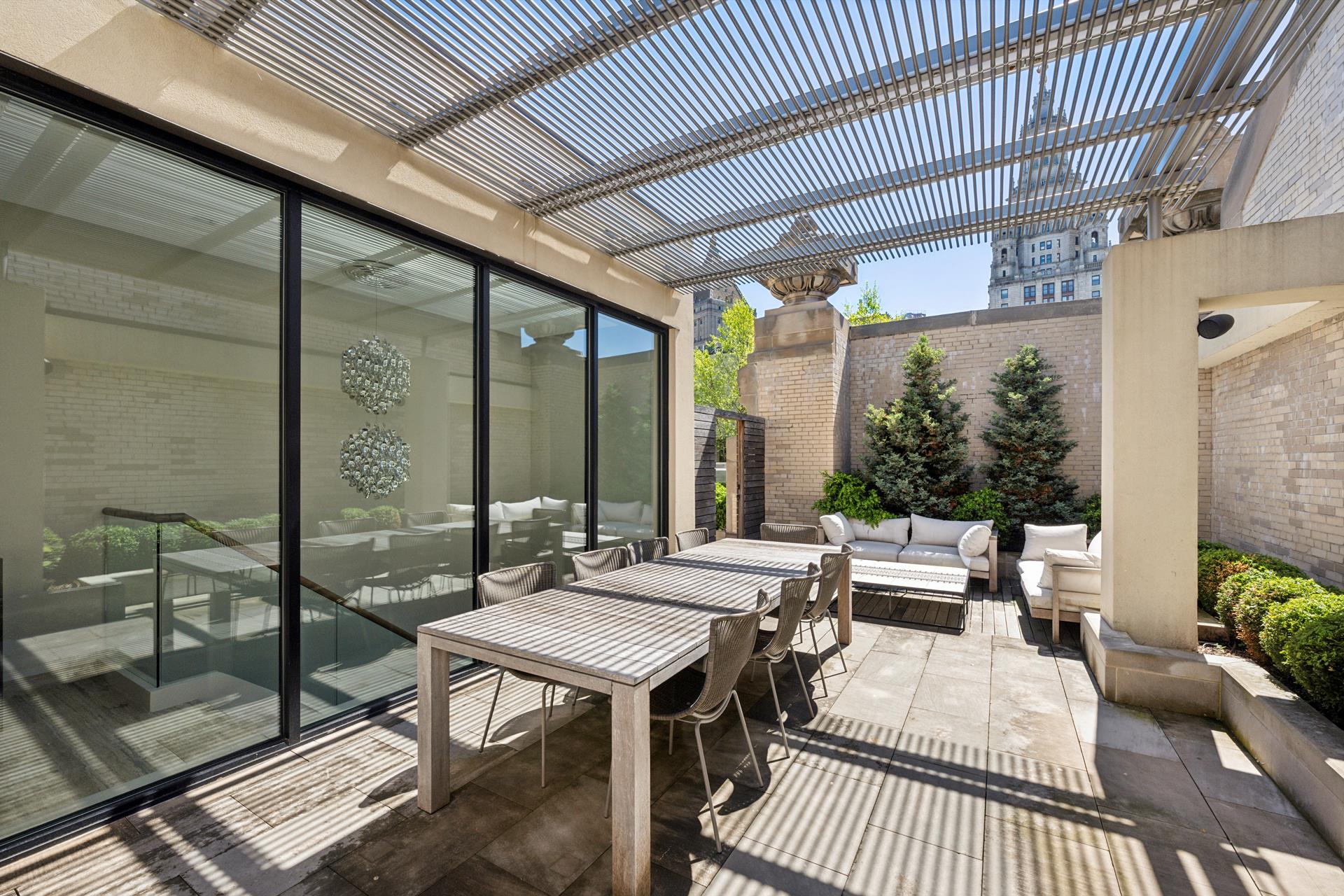 49 Chambers Street, Unit PHB Manhattan, NY 10007 - Photo 18 of 35 a view of a patio with a dining table and chairs with wooden floor