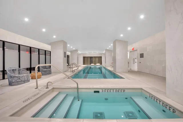 a living room with furniture and a mirror