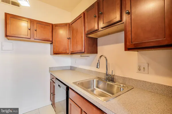 a kitchen with a sink cabinets and stainless steel appliances