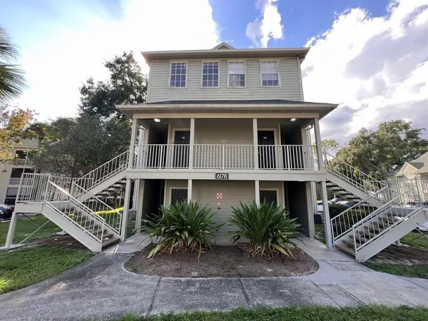 a front view of a house with plants