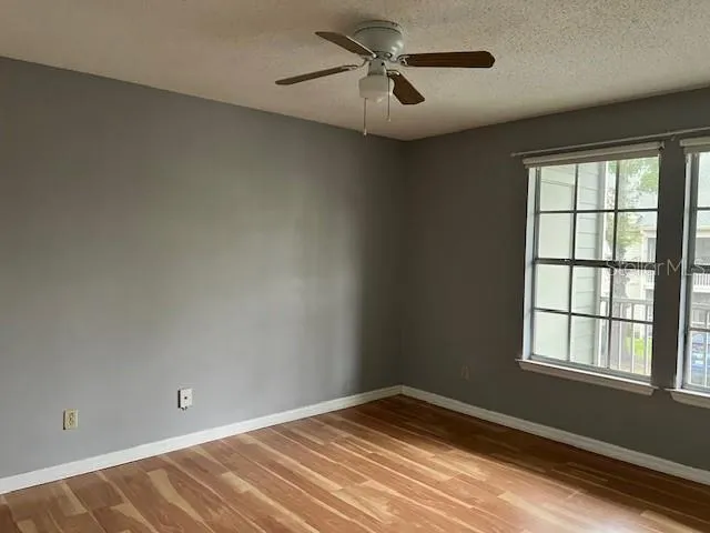 a view of empty room with ceiling fan