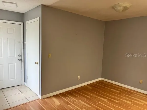 a view of empty room with wooden floor