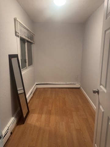 166 A Chelsea Street, Unit 1 Boston, MA 02128 - Photo 13 of 13 a view of a room with wooden floor and white walls
