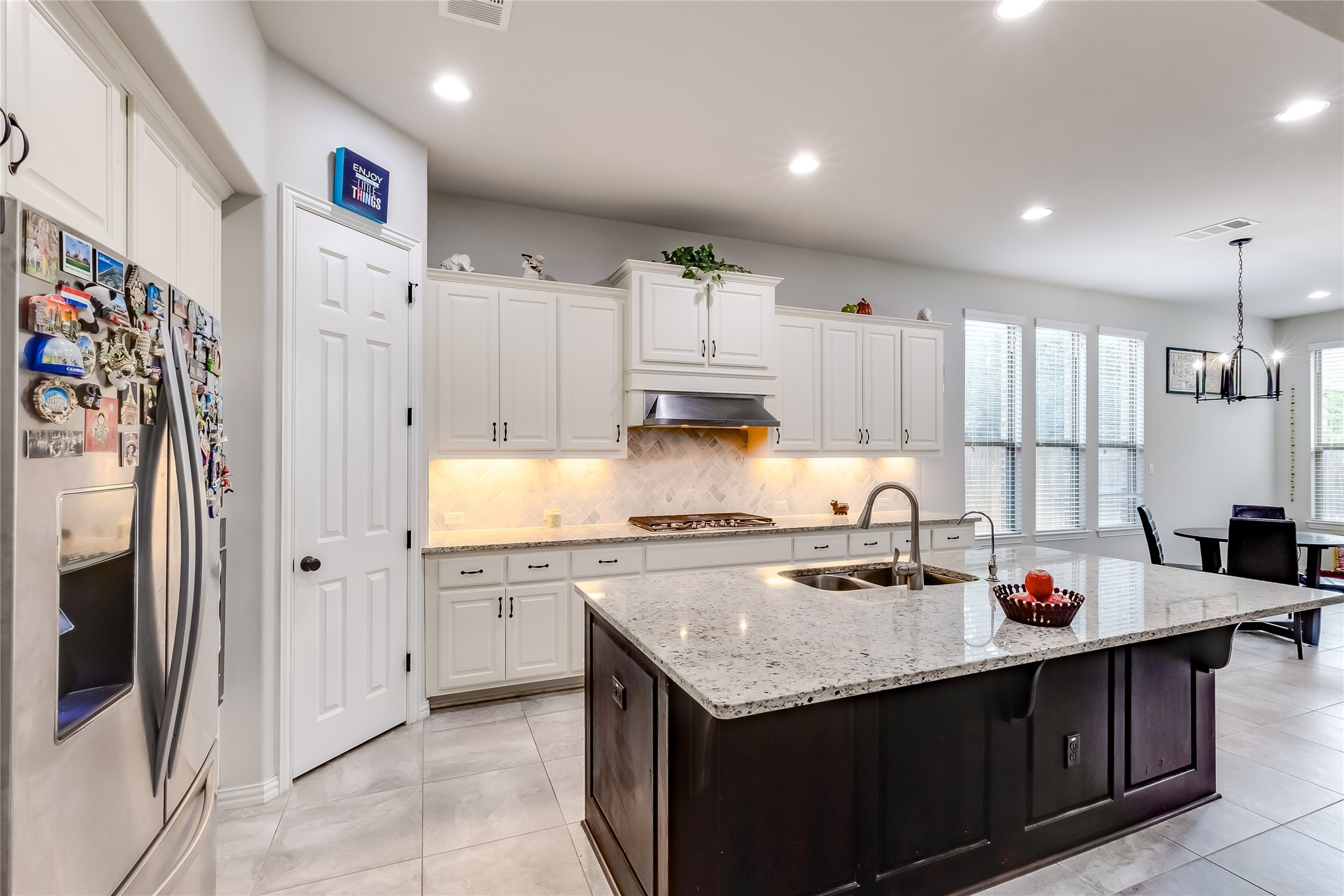 204 Lady Bird Lane Georgetown, TX 78628 - Photo 11 of 40 a kitchen with stainless steel appliances granite countertop a sink stove and refrigerator