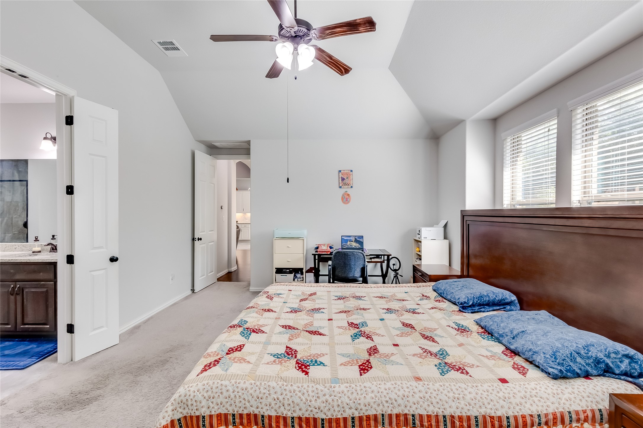 204 Lady Bird Lane Georgetown, TX 78628 - Photo 16 of 40 a bedroom with a bed and a chandelier