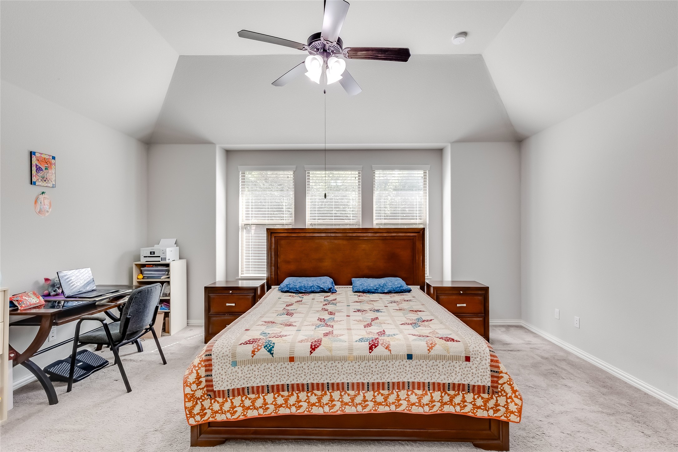 204 Lady Bird Lane Georgetown, TX 78628 - Photo 18 of 40 a bed sitting in a bedroom next to a window with a chandelier