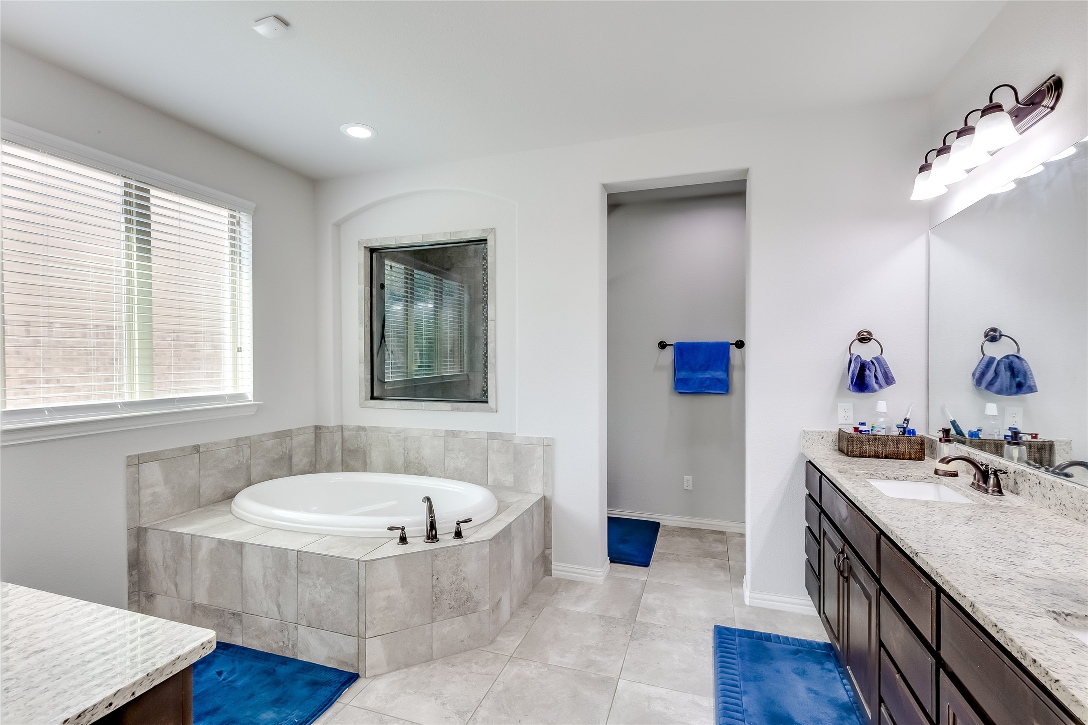 204 Lady Bird Lane Georgetown, TX 78628 - Photo 19 of 40 a bathroom with a tub sink and mirror
