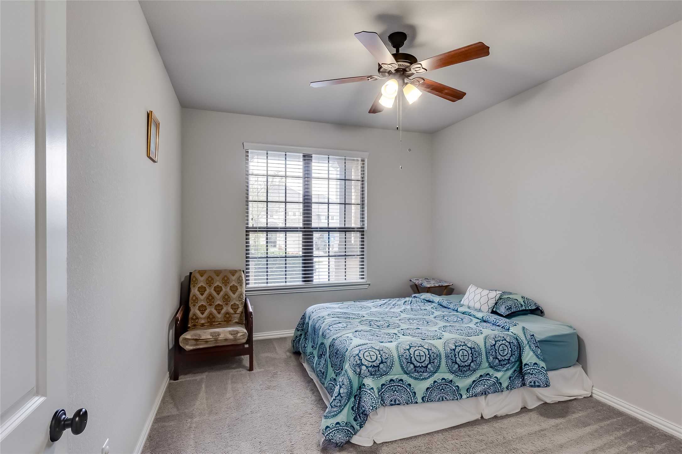 204 Lady Bird Lane Georgetown, TX 78628 - Photo 21 of 40 a bedroom with a bed and a ceiling fan