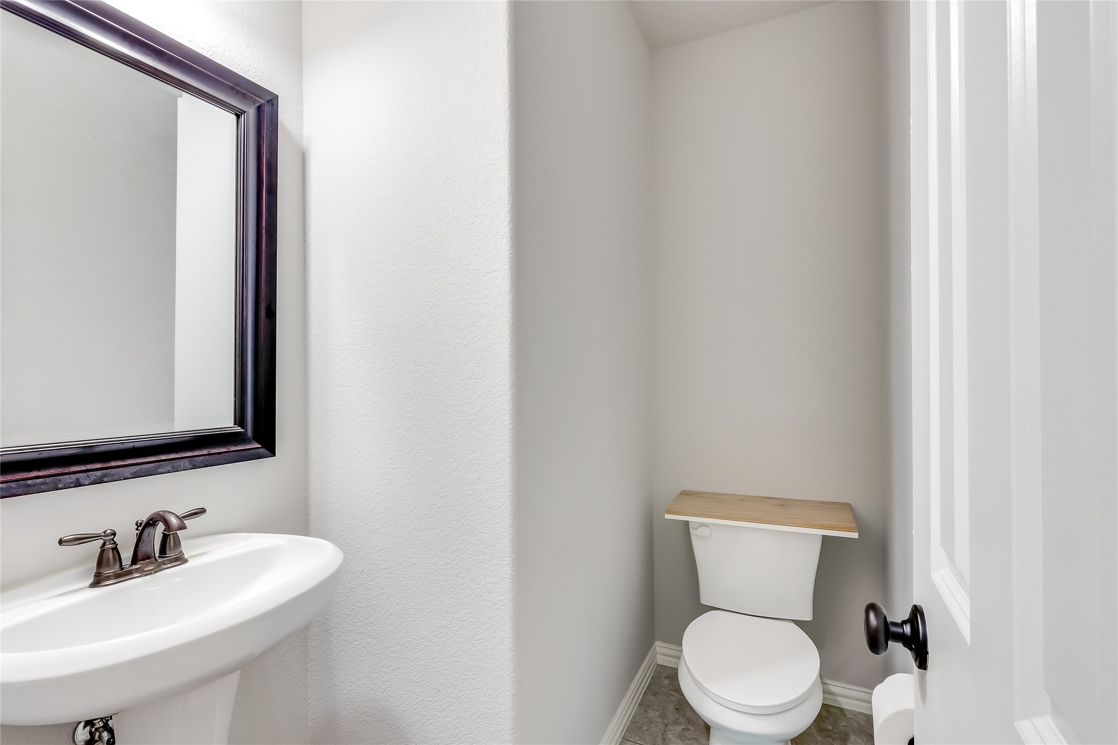 204 Lady Bird Lane Georgetown, TX 78628 - Photo 24 of 40 a bathroom with a toilet a sink and mirror