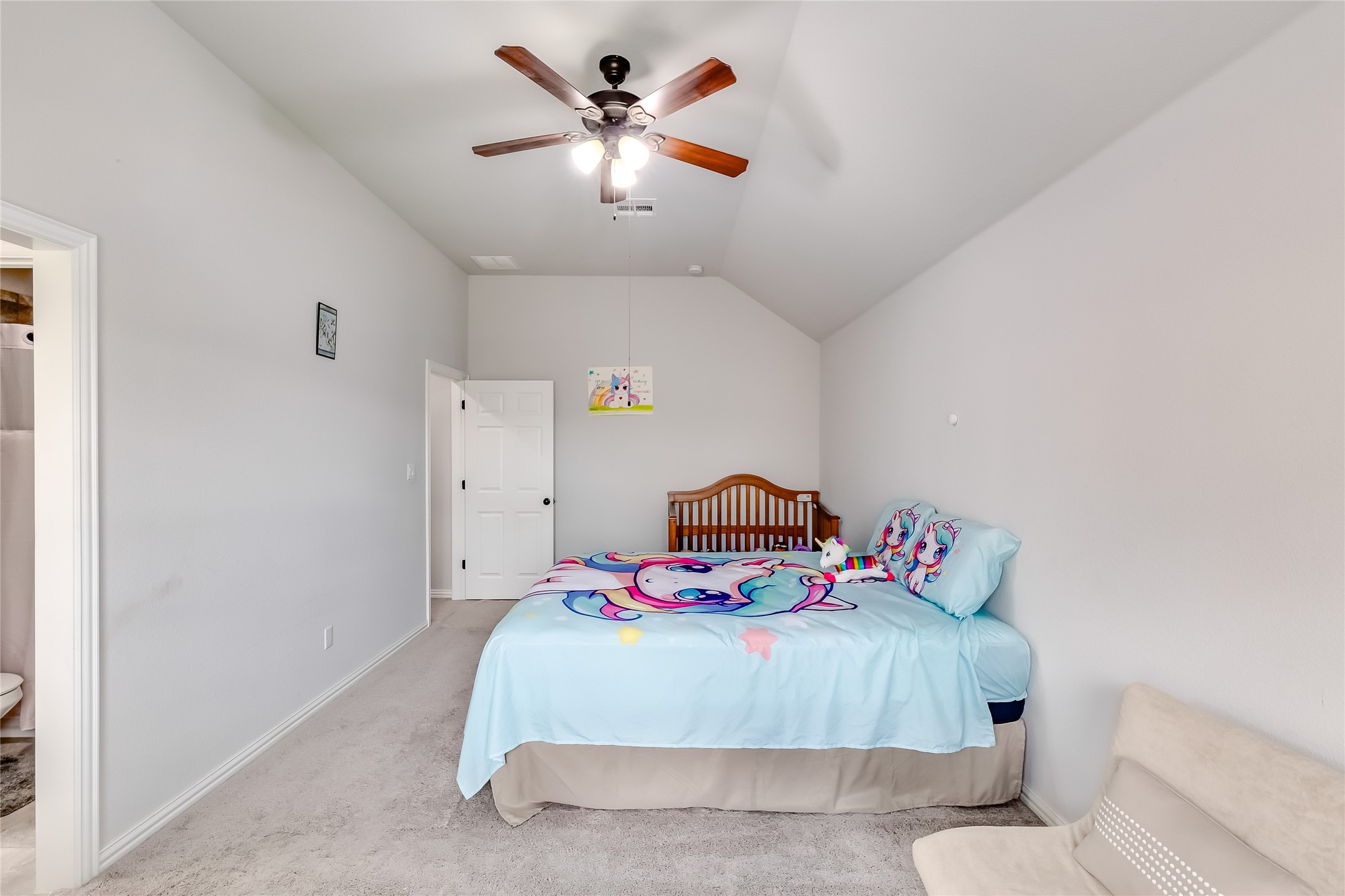 204 Lady Bird Lane Georgetown, TX 78628 - Photo 26 of 40 a bedroom with a bed and a chandelier