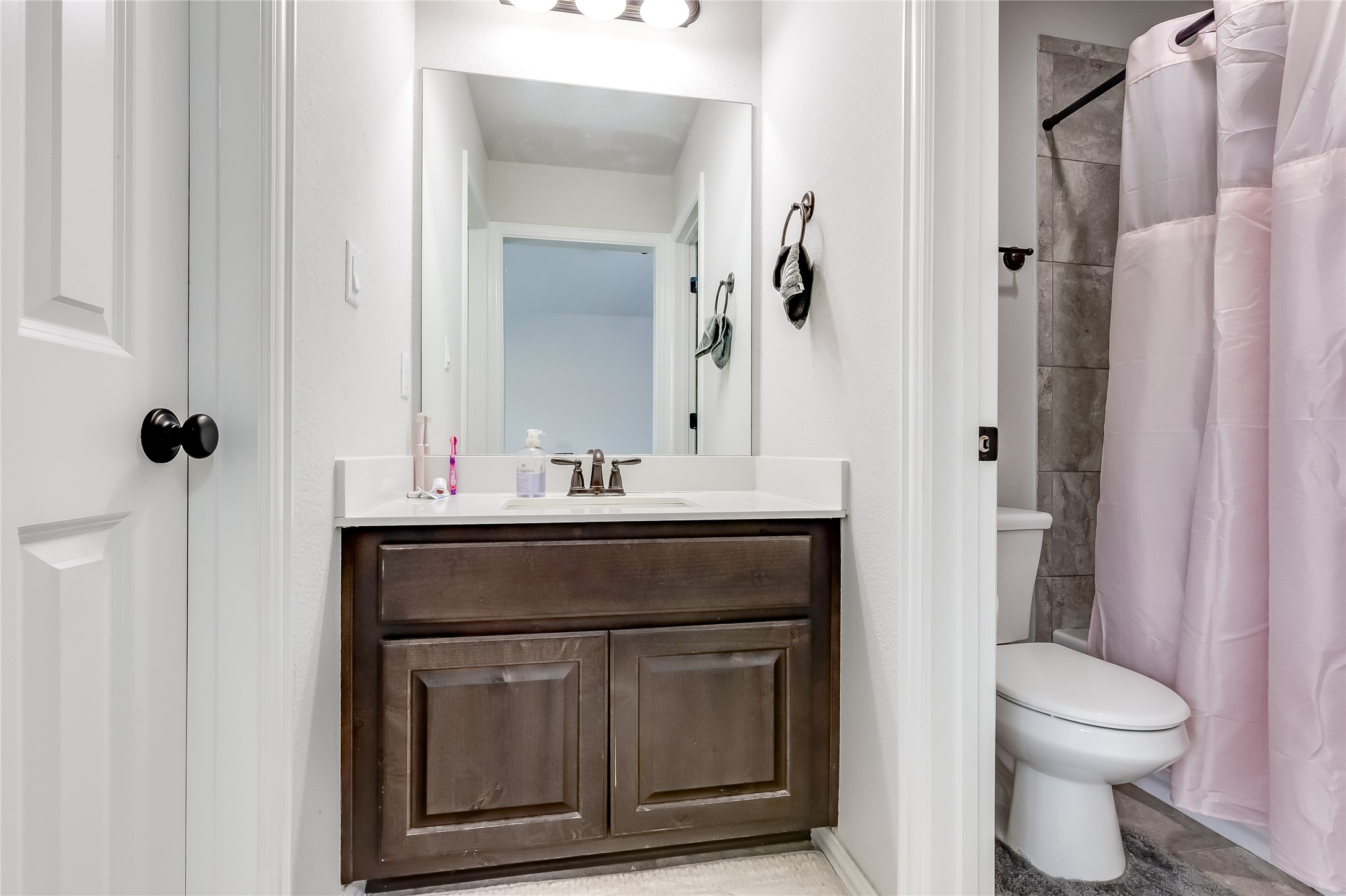 204 Lady Bird Lane Georgetown, TX 78628 - Photo 27 of 40 a bathroom with a sink vanity and toilet