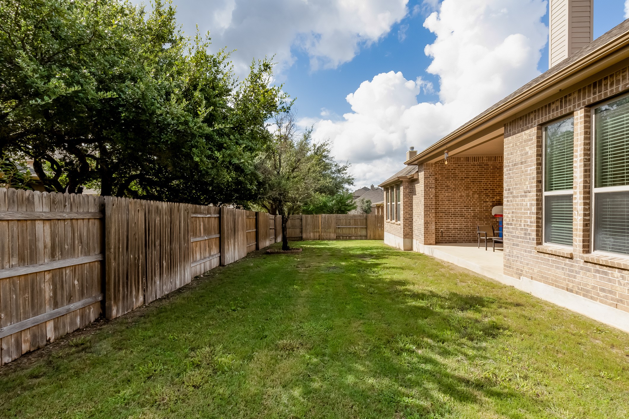 204 Lady Bird Lane Georgetown, TX 78628 - Photo 37 of 40 a view of a backyard with tree s