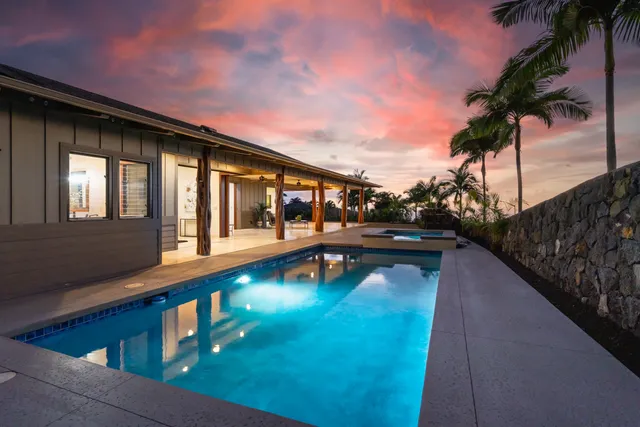 an aerial view of a house with a garden and a yard