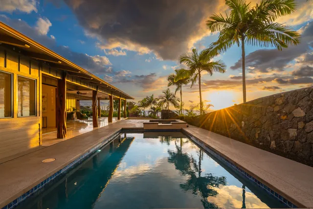 a kitchen with stainless steel appliances a stove a sink a oven a dining table and chairs