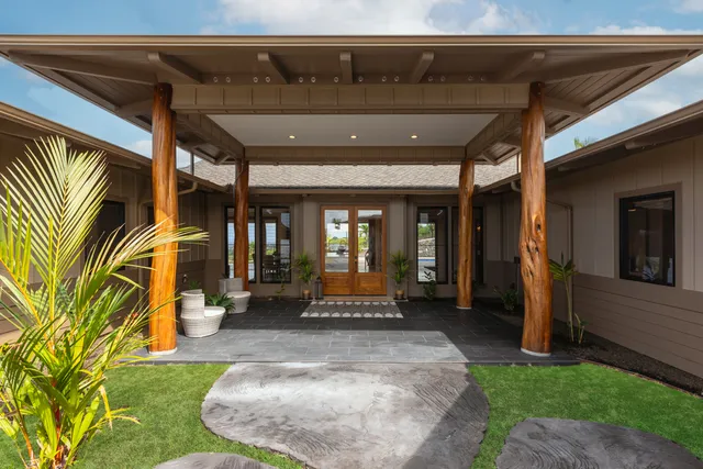 an aerial view of residential houses with outdoor space and parking