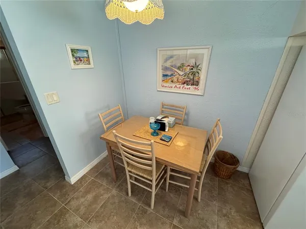 a dining room with furniture and a rug