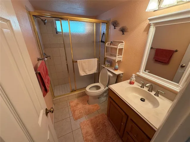 a bathroom with a sink mirror vanity and toilet
