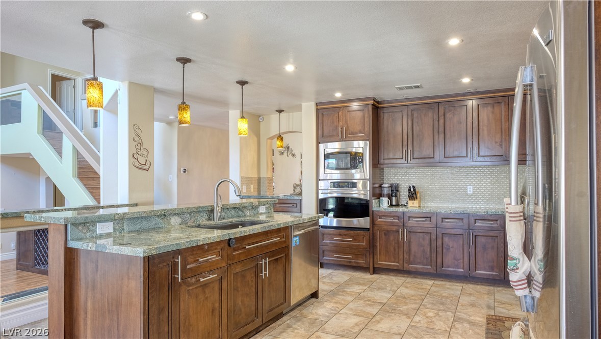3704 North Campbell Road Las Vegas, NV 89129 - Photo 13 of 38 Granite counters and stainless steel appliances complete this spacious, open-concept kitchen.