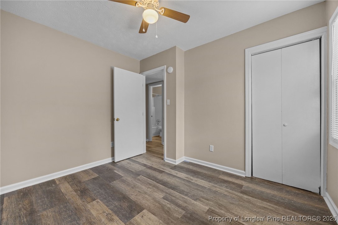 735 Ashbrook Road Fayetteville, NC 28314 - Photo 15 of 39 an empty room with a chandelier fan and closet area
