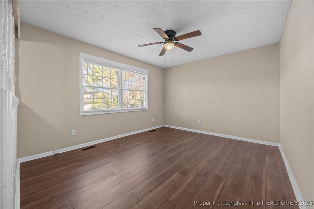 735 Ashbrook Road Fayetteville, NC 28314 - Photo 17 of 39 a view of an empty room with wooden floor and a window