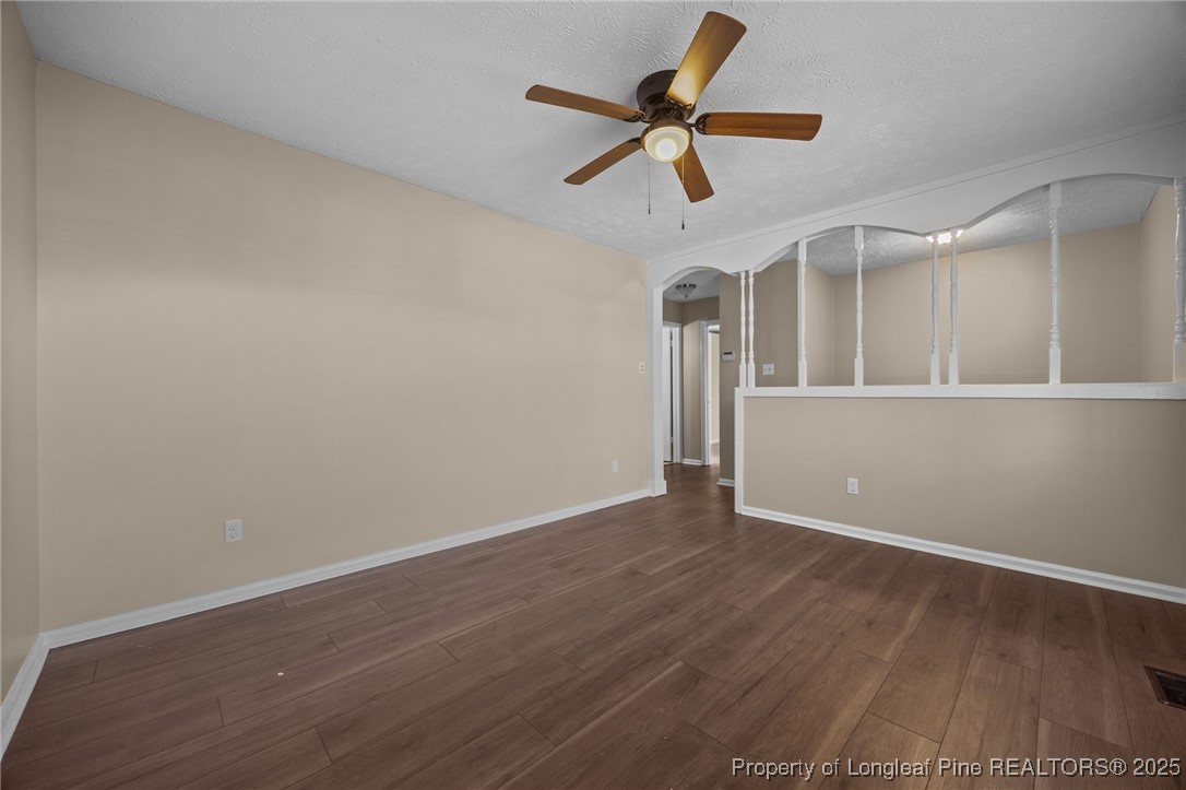 735 Ashbrook Road Fayetteville, NC 28314 - Photo 18 of 39 an empty room with wooden floor and ceiling fan
