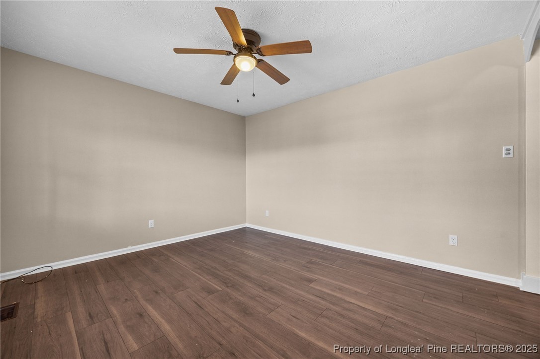 735 Ashbrook Road Fayetteville, NC 28314 - Photo 20 of 39 an empty room with wooden floor and a ceiling fan
