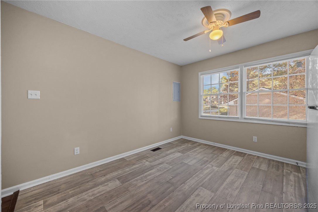 735 Ashbrook Road Fayetteville, NC 28314 - Photo 26 of 39 an empty room with a window and ceiling fan