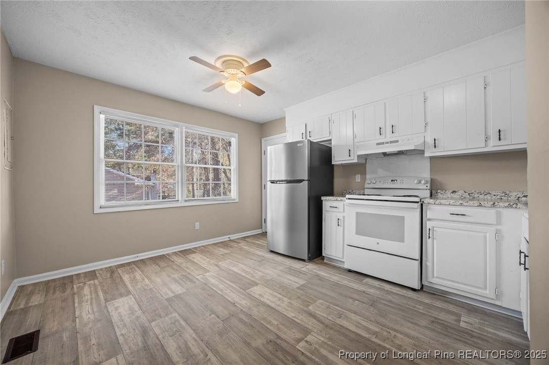 735 Ashbrook Road Fayetteville, NC 28314 - Photo 27 of 39 a kitchen with white cabinets and white appliances