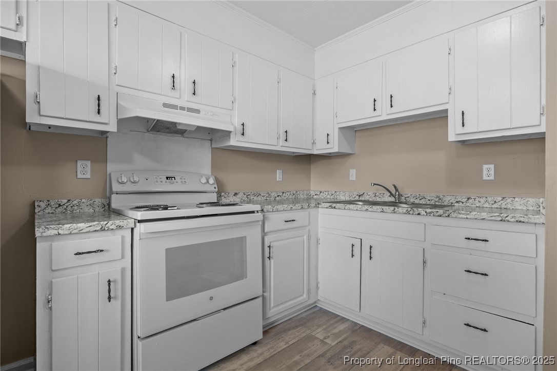 735 Ashbrook Road Fayetteville, NC 28314 - Photo 30 of 39 a kitchen with granite countertop white cabinets and white appliances