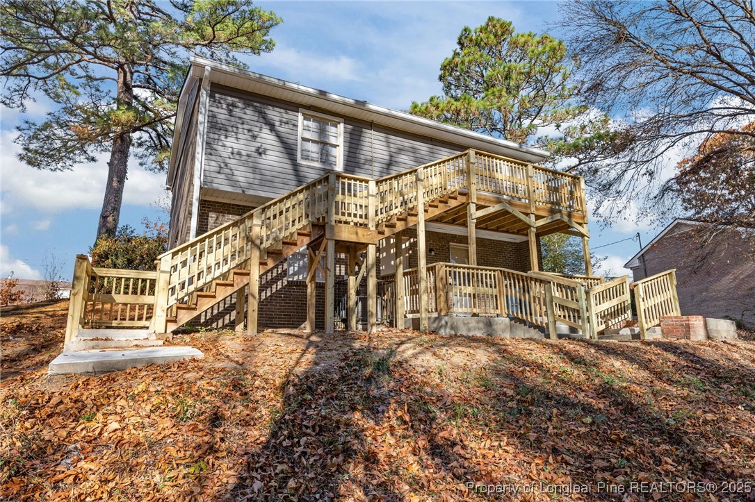 735 Ashbrook Road Fayetteville, NC 28314 - Photo 35 of 39 a view of a house with a small yard and wooden fence