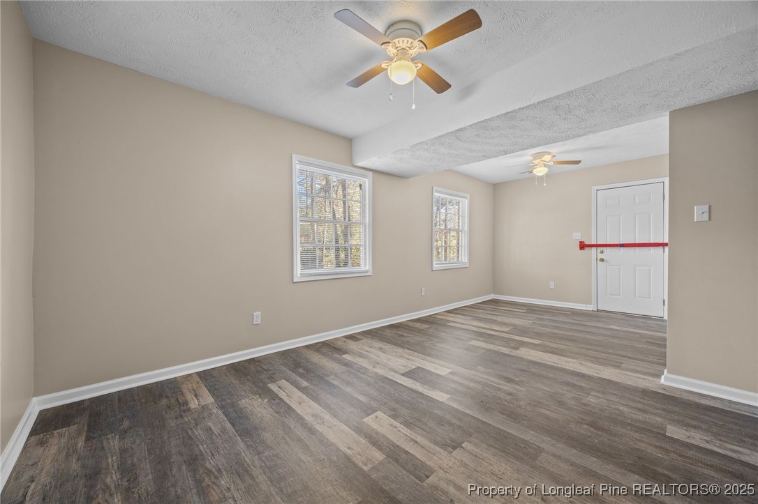 735 Ashbrook Road Fayetteville, NC 28314 - Photo 8 of 39 an empty room with windows and a ceiling fan