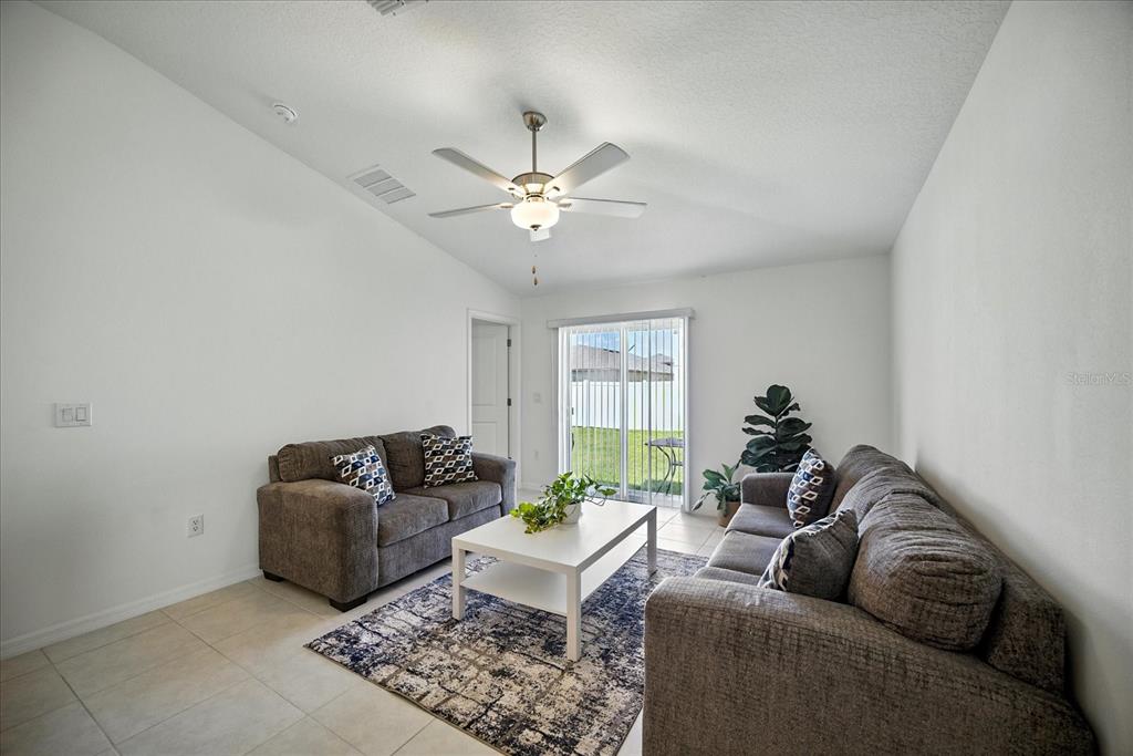 73 Rain Lily Ave Spring Hill Spring Hill, FL 34609 - Photo 13 of 37 a living room with furniture and a window