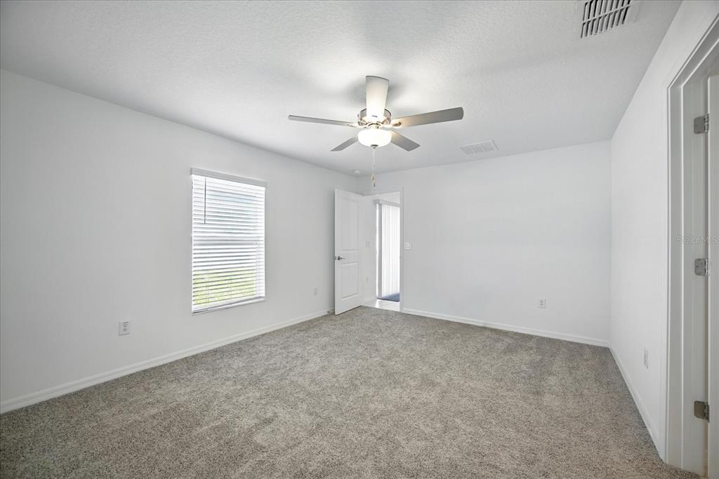 73 Rain Lily Ave Spring Hill Spring Hill, FL 34609 - Photo 17 of 37 an empty room with windows and fan
