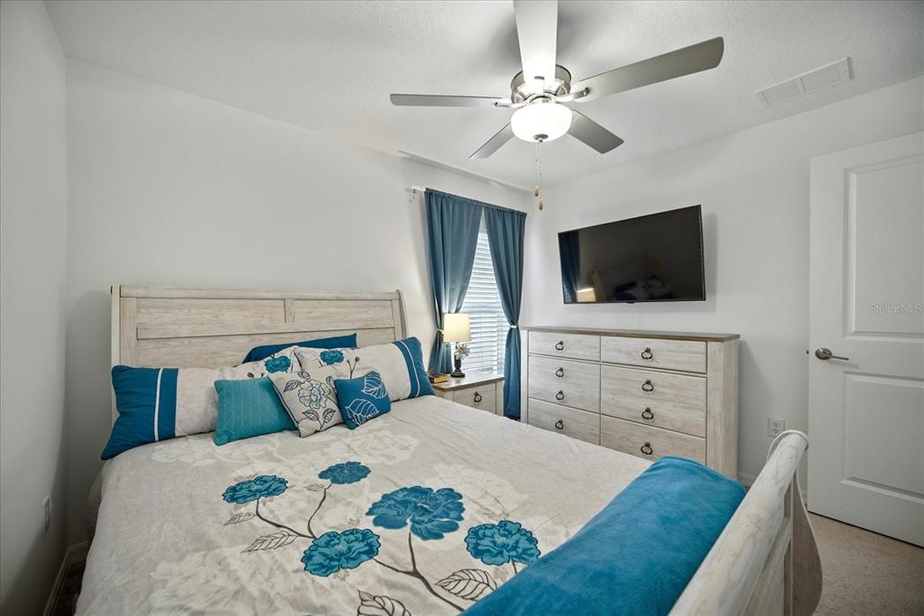 73 Rain Lily Ave Spring Hill Spring Hill, FL 34609 - Photo 25 of 37 a bedroom with a bed and a flat screen tv