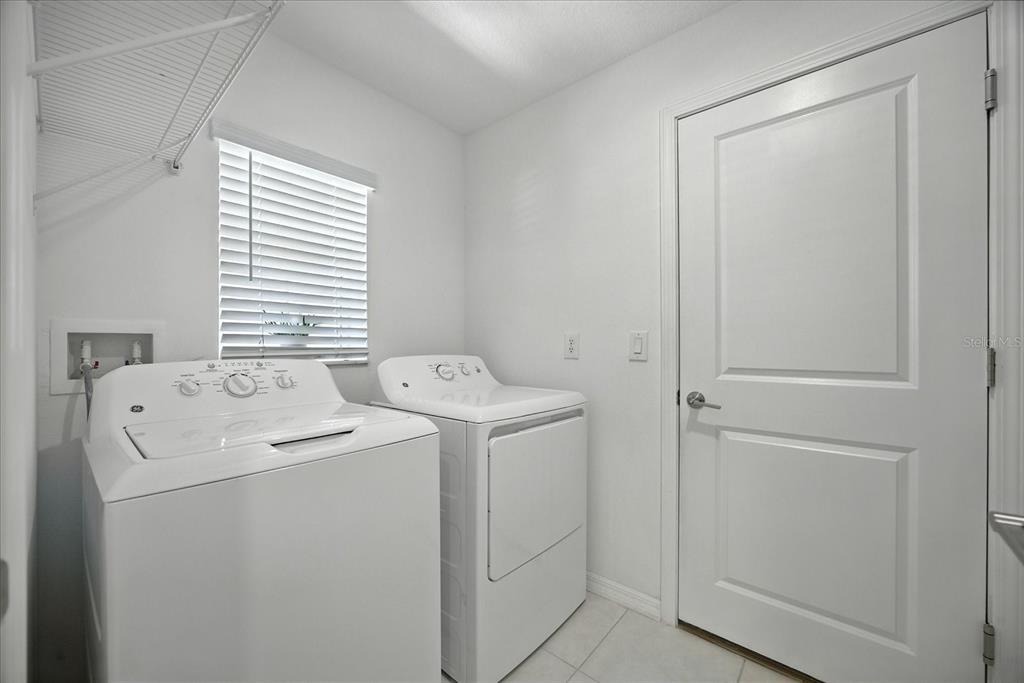 73 Rain Lily Ave Spring Hill Spring Hill, FL 34609 - Photo 27 of 37 a utility room with dryer and washer