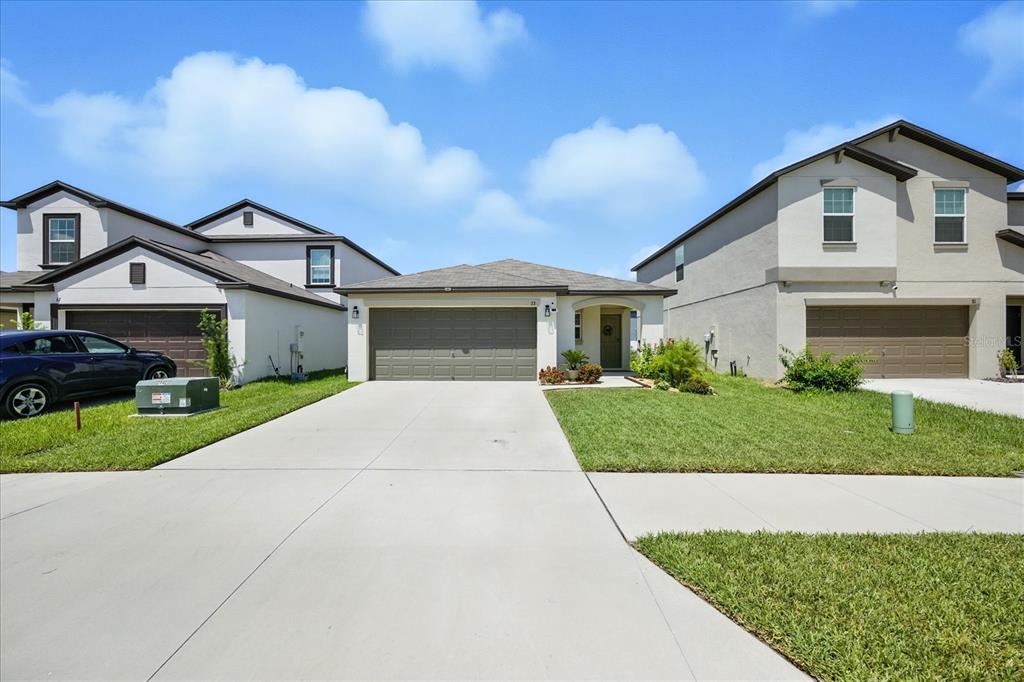 73 Rain Lily Ave Spring Hill Spring Hill, FL 34609 - Photo 37 of 37 a front view of a house with a yard and garage