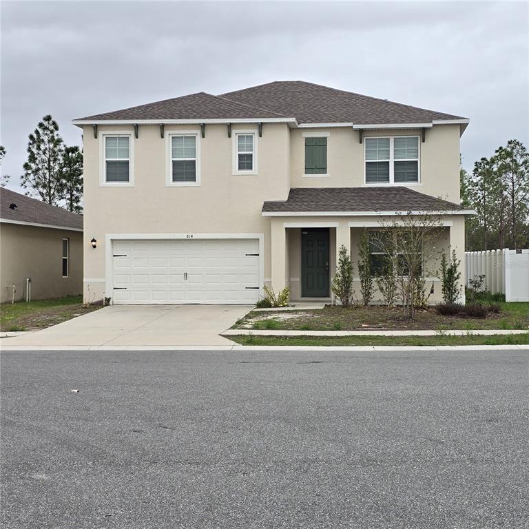 814 Sun Burst Road Winter Haven, FL 33880 - Photo 46 of 48 a front view of a house with a yard and garage