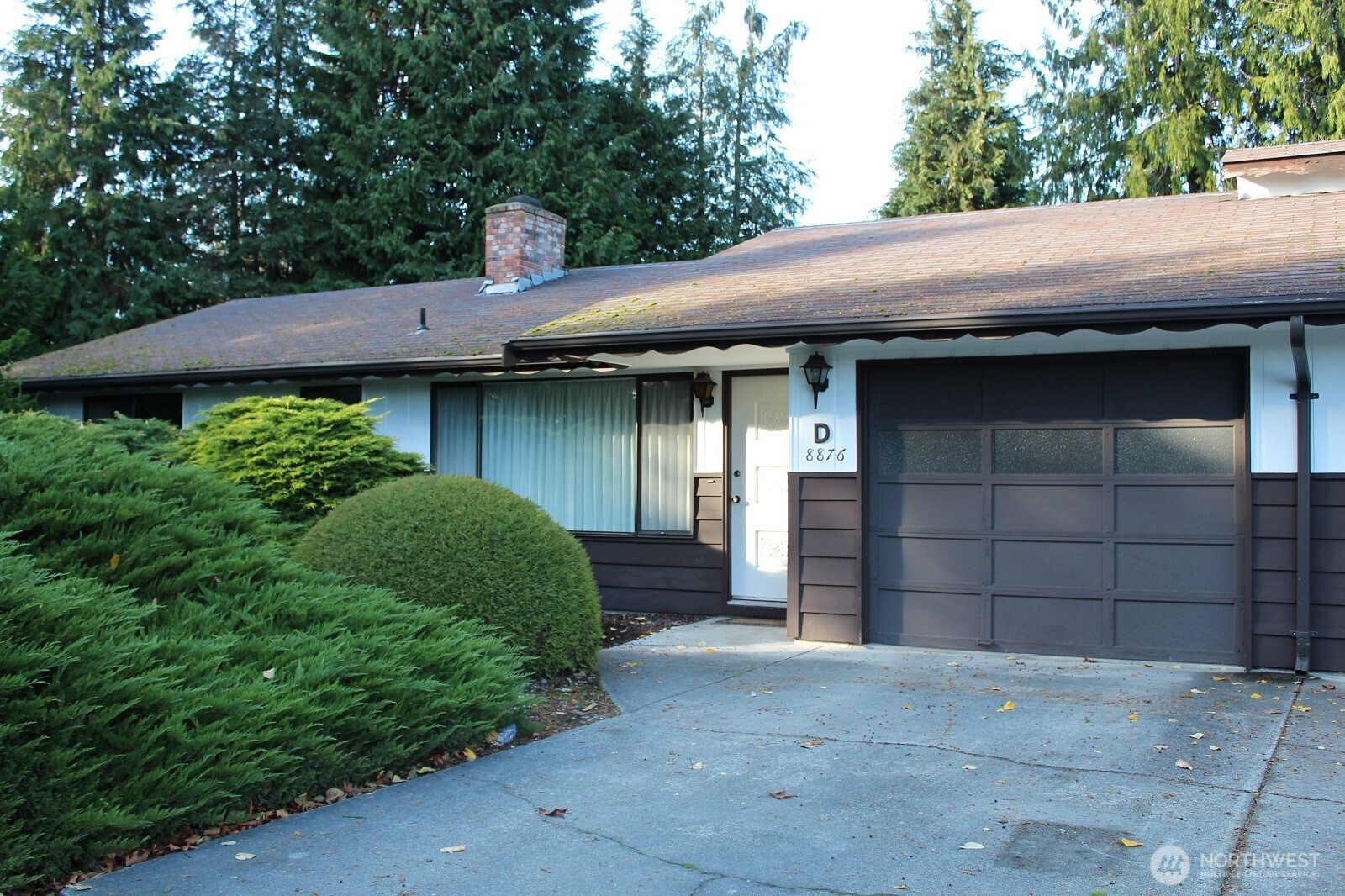 8876 Old Olympic Highway, Unit D Sequim, WA 98382 - Photo 1 of 26 a front view of a house with a yard and garage