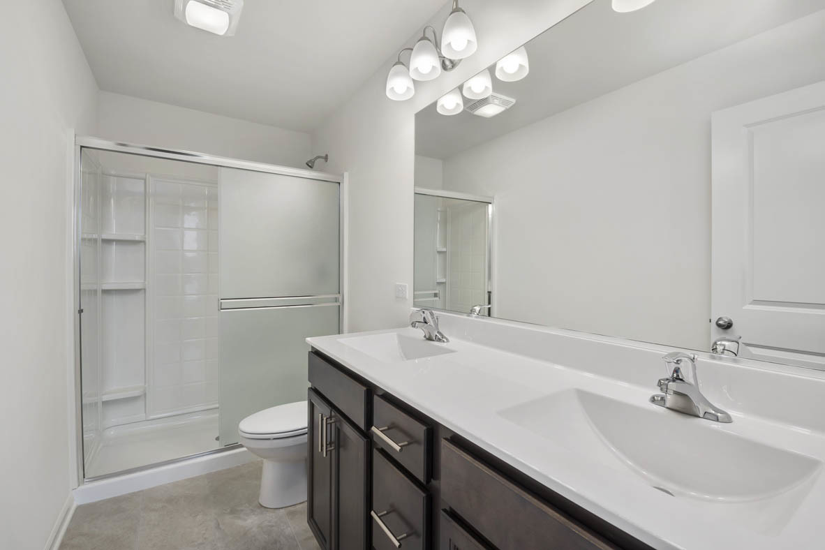 2241 Venture Drive Schaumburg, IL 60173 - Photo 11 of 33 a bathroom with a sink a toilet a mirror and shower