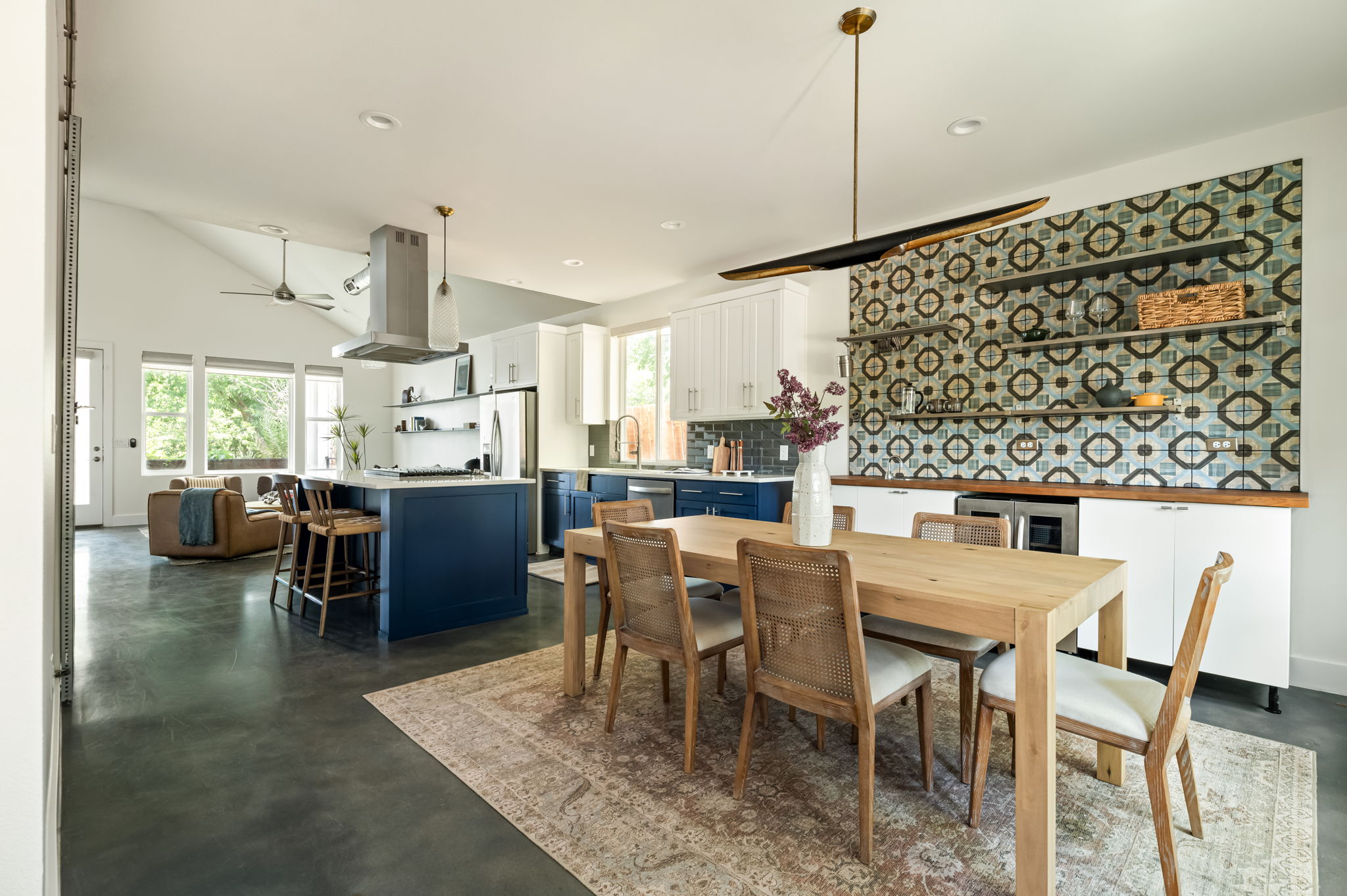 1902 Webberville Road, Unit B Austin, TX 78721 - Photo 2 of 39 An open-concept living space integrates a stylish kitchen with bold blue cabinetry and a casual dining area.