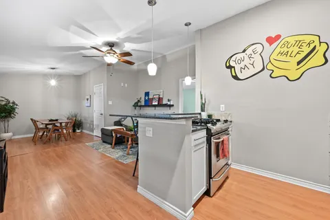 a kitchen with a refrigerator and a stove top oven