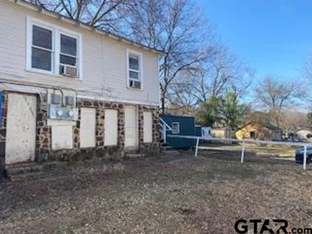 a view of a house with a yard and sitting area