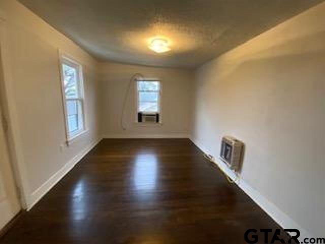 309 East Rix Street, Unit B Tyler, TX 75701 - Photo 3 of 9 a view of an empty room with wooden floor and a window
