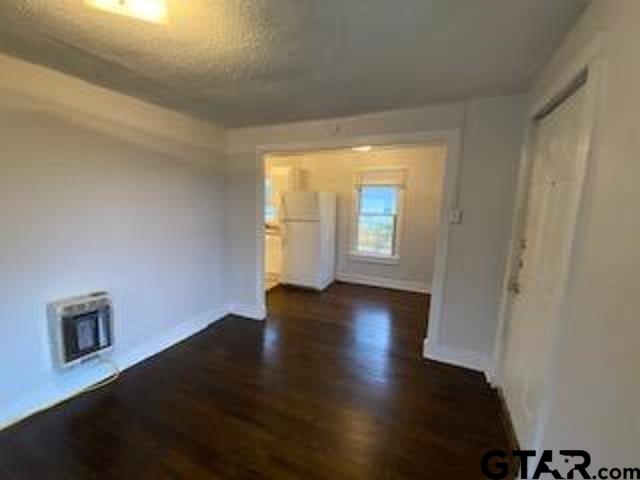 309 East Rix Street, Unit B Tyler, TX 75701 - Photo 4 of 9 an empty room with wooden floor and windows
