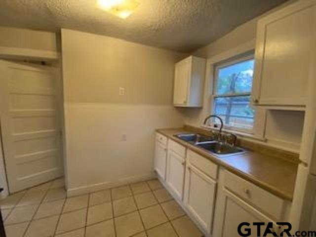 309 East Rix Street, Unit B Tyler, TX 75701 - Photo 5 of 9 a kitchen with a sink and cabinets