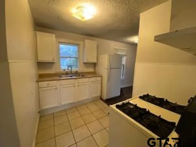 a kitchen with a stove and a refrigerator