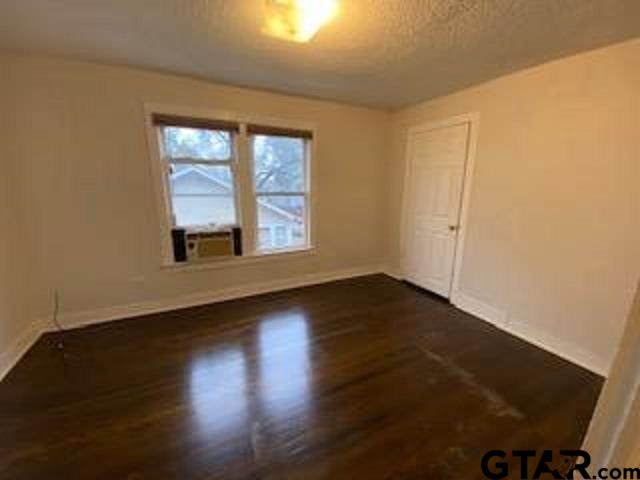 309 East Rix Street, Unit B Tyler, TX 75701 - Photo 9 of 9 a view of an empty room with wooden floor and a window