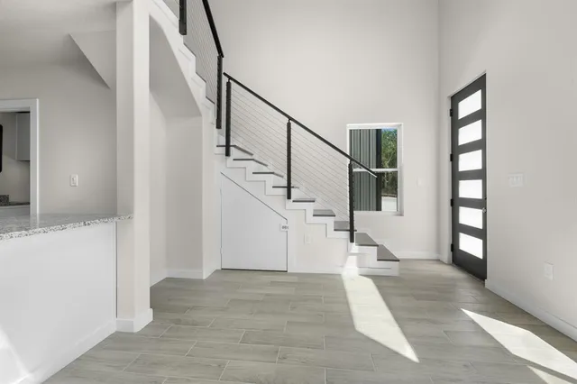 a view of entryway and hall with wooden floor