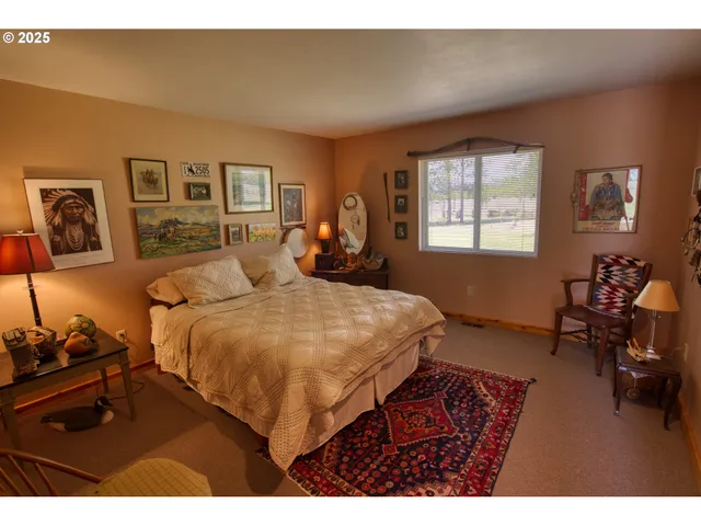 a bedroom with a bed window and dresser