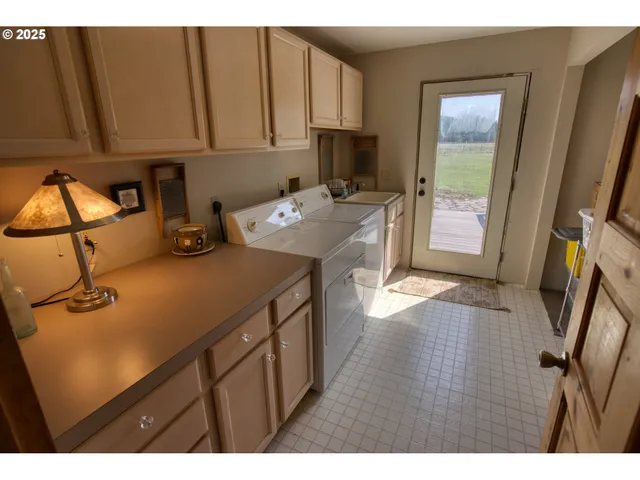 a utility room with closet dryer and washer